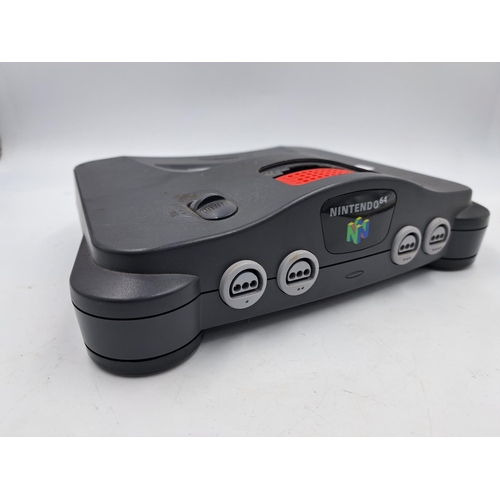 735 - A Nintendo N64 console with controller, cables, Memory Card Plus, TremorPak and games to include Fif... 