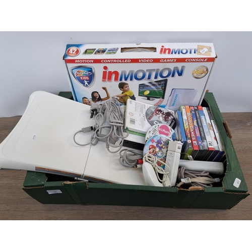 738 - A collection of gaming related items to include Nintendo Wii console with Wii Fit board, controllers... 