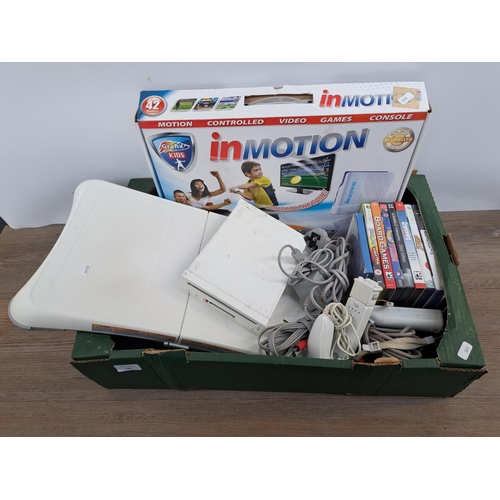 738 - A collection of gaming related items to include Nintendo Wii console with Wii Fit board, controllers... 