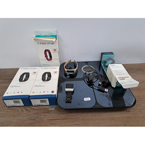 763 - A collection of Fitbit items to include boxed two Charge 2, boxed Alta HR, boxed Flex, Aria WiFi Sma... 