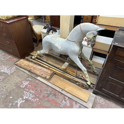 113 - A Victorian style grey painted fibreglass rocking horse on pine stand - approx. 106cm high x 51cm wi... 