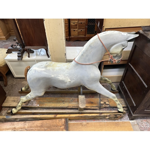 113 - A Victorian style grey painted fibreglass rocking horse on pine stand - approx. 106cm high x 51cm wi... 