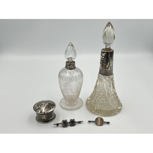 2298 - Five silver items, two brooches, one hallmarked London scent bottle top, one etched glass scent bott... 