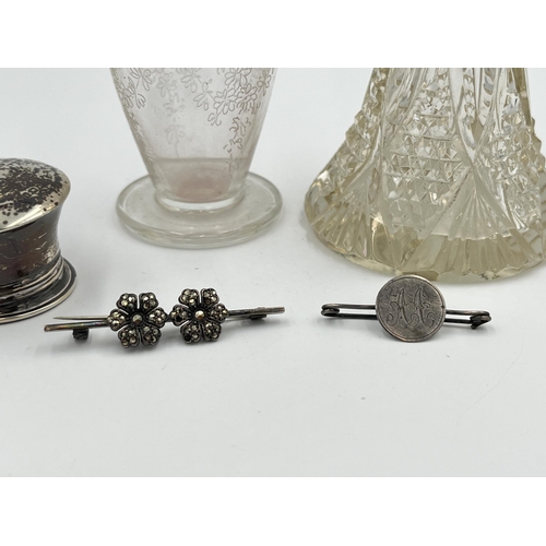 2298 - Five silver items, two brooches, one hallmarked London scent bottle top, one etched glass scent bott... 