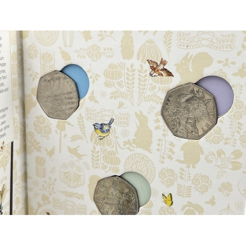 2303 - Three The Royal Mint Beatrix Potter 50p coin items, one Celebrating The Wonder World of Miss Potter ... 