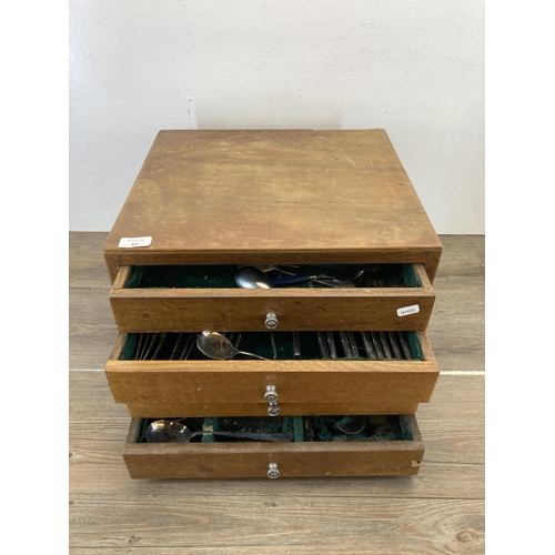 416 - A mid 20th century oak four drawer canteen of cutlery