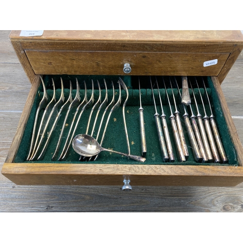 416 - A mid 20th century oak four drawer canteen of cutlery