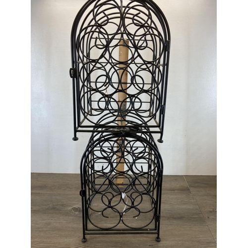 418 - A pair of black metal eleven section bottle racks - each approx. 44cm high