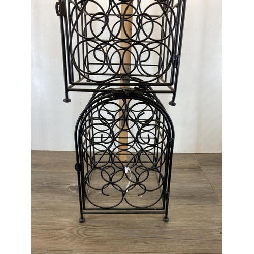 418 - A pair of black metal eleven section bottle racks - each approx. 44cm high