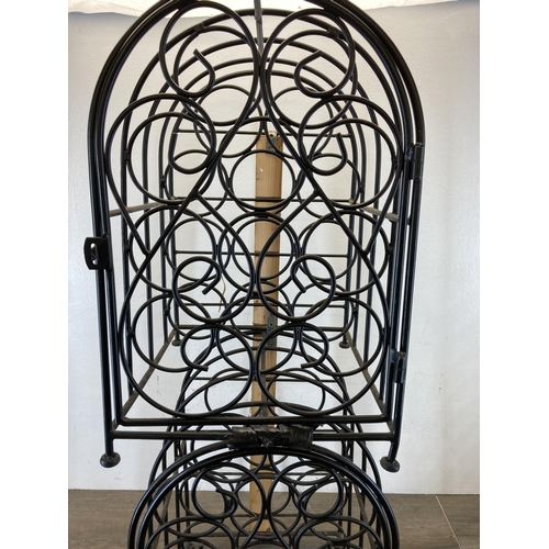 418 - A pair of black metal eleven section bottle racks - each approx. 44cm high