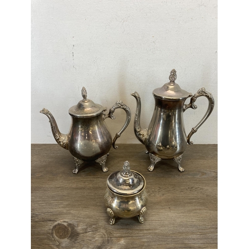 420 - A collection of metalware to include brass measuring jugs, mid 20th century EPNS tea and coffee set ... 