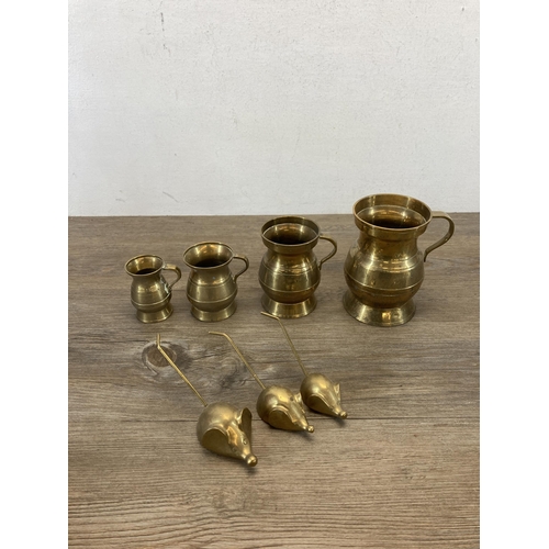 420 - A collection of metalware to include brass measuring jugs, mid 20th century EPNS tea and coffee set ... 