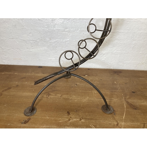 425 - A large bespoke made wrought iron snake shaped ten section floor standing bottle rack - approx. 91cm... 