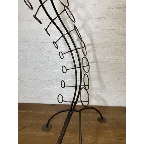 425 - A large bespoke made wrought iron snake shaped ten section floor standing bottle rack - approx. 91cm... 