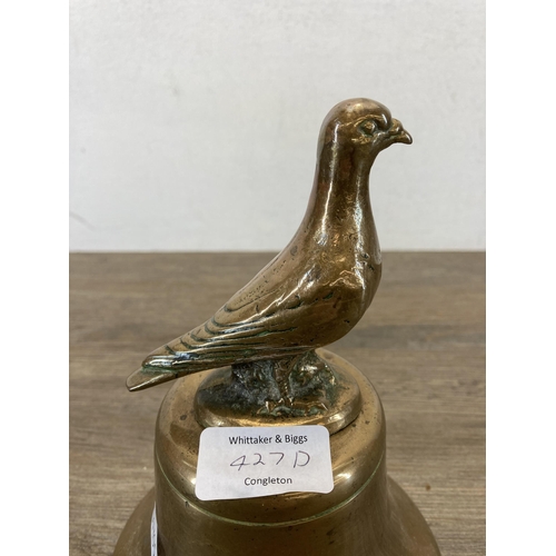 427D - A 19th century brass bell with cast pigeon top - approx. 21cm high x 14cm diameter