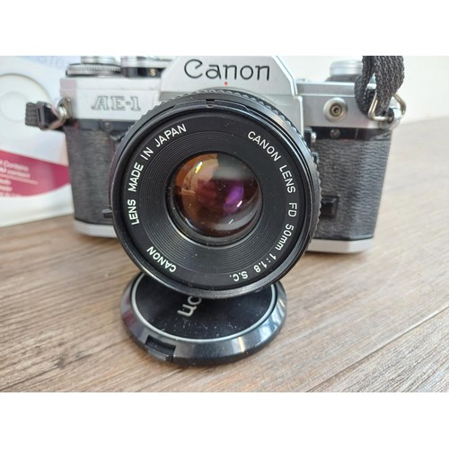 646 - Two cameras, one Canon AE-1 35mm SLR fitted with FD 50mm 1:1.8 S.C. lens and one boxed and cased Sam... 