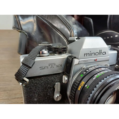 654 - Two camera cases containing Minolta SRT101 35mm SLR camera, Chinon CE-3 Memotron 35mm SLR camera fit... 