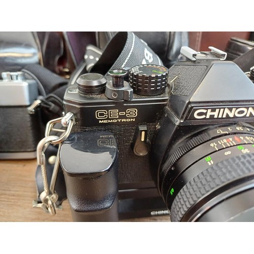 654 - Two camera cases containing Minolta SRT101 35mm SLR camera, Chinon CE-3 Memotron 35mm SLR camera fit... 