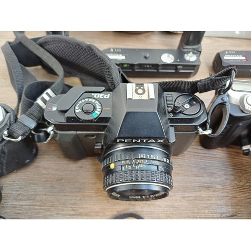 669 - A collection of Pentax items to include MG, P30N, MZ-50 and P30T 35mm SLR cameras etc.