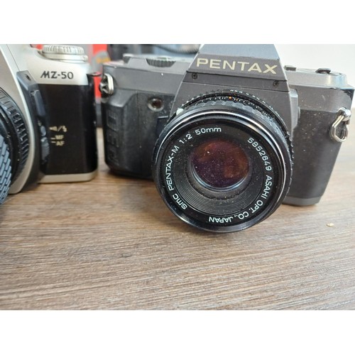 669 - A collection of Pentax items to include MG, P30N, MZ-50 and P30T 35mm SLR cameras etc.