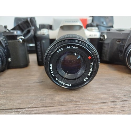 669 - A collection of Pentax items to include MG, P30N, MZ-50 and P30T 35mm SLR cameras etc.