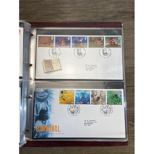 498 - Six albums containing a large collection of Royal Mail first day covers to include Winnie the Pooh, ... 