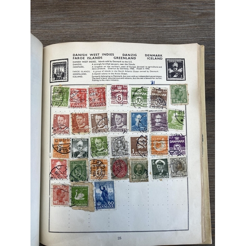 514 - An album containing a collection of worldwide stamps together with a collection of cigarette cards