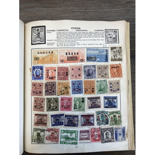 514 - An album containing a collection of worldwide stamps together with a collection of cigarette cards