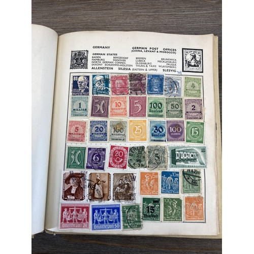 514 - An album containing a collection of worldwide stamps together with a collection of cigarette cards