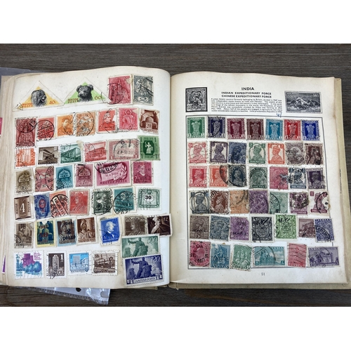 514 - An album containing a collection of worldwide stamps together with a collection of cigarette cards