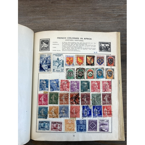 514 - An album containing a collection of worldwide stamps together with a collection of cigarette cards