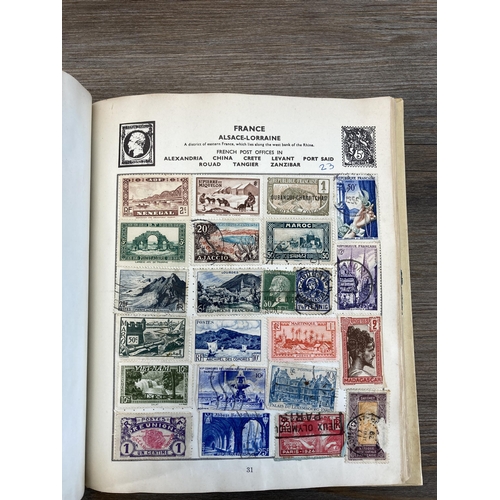 514 - An album containing a collection of worldwide stamps together with a collection of cigarette cards