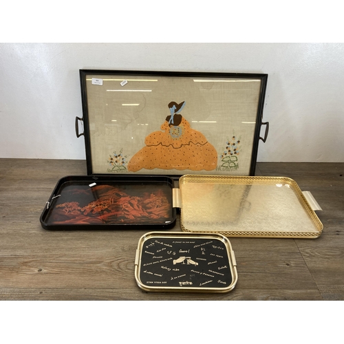 535 - Four vintage serving trays to include embroidered etc. - largest approx. 66cm long x 40.5cm wide