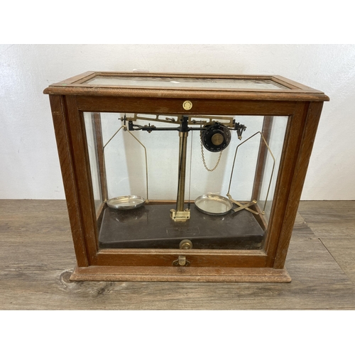 537 - A set of early 20th century oak cased Griffin & Tatlock Ltd of London analytical balance scales