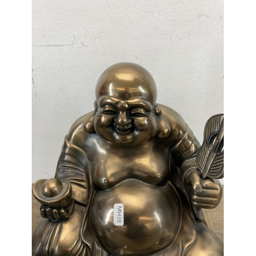 541 - A large contemporary gold painted seated Buddha figurine - approx. 48cm high x 28cm wide