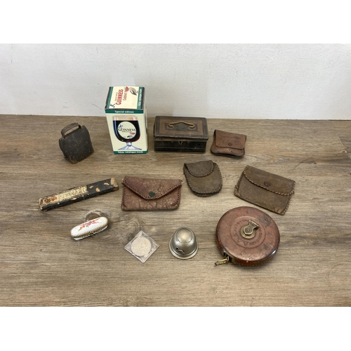 558 - A collection of items to include early 20th century brown leather Hockley Abbey of England tape meas... 