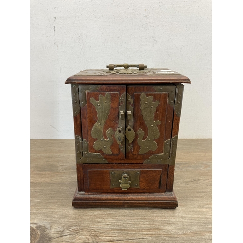 562 - A vintage Chinese hardwood miniature three door cabinet with brass details and original lock and key... 