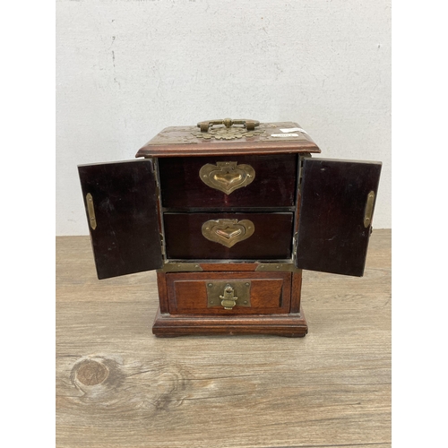 562 - A vintage Chinese hardwood miniature three door cabinet with brass details and original lock and key... 