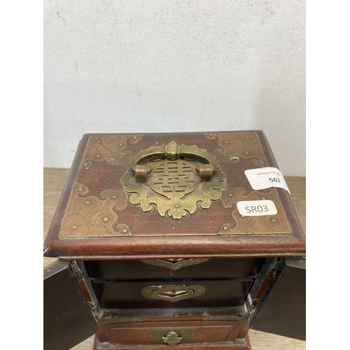 562 - A vintage Chinese hardwood miniature three door cabinet with brass details and original lock and key... 