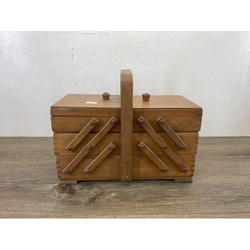 576 - A mid 20th century teak concertina sewing box