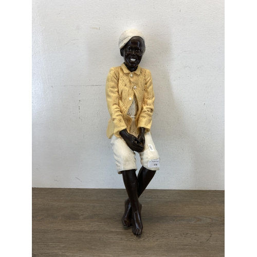 578 - A hand painted chalkware seated gentleman bookshelf figurine - approx. 52cm high