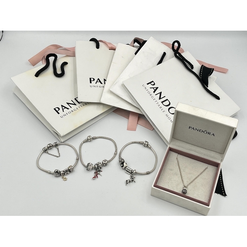 2416 - Four pieces of Pandora .925 silver jewellery, three charm bracelets with assorted charms and one pen... 