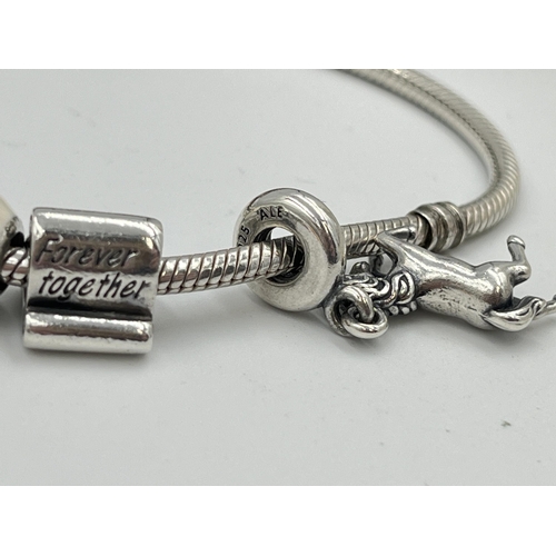 2416 - Four pieces of Pandora .925 silver jewellery, three charm bracelets with assorted charms and one pen... 