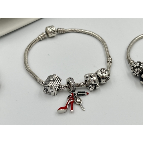 2416 - Four pieces of Pandora .925 silver jewellery, three charm bracelets with assorted charms and one pen... 