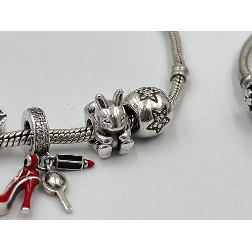 2416 - Four pieces of Pandora .925 silver jewellery, three charm bracelets with assorted charms and one pen... 