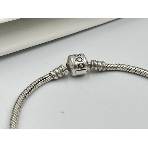 2416 - Four pieces of Pandora .925 silver jewellery, three charm bracelets with assorted charms and one pen... 