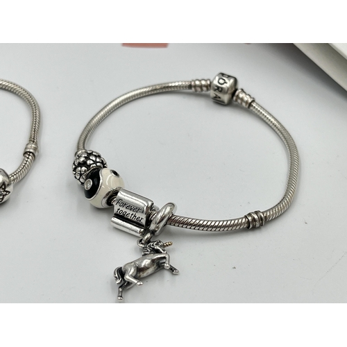 2416 - Four pieces of Pandora .925 silver jewellery, three charm bracelets with assorted charms and one pen... 