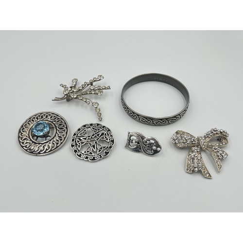 2418 - Six pieces of costume jewellery to include St Justin pewter brooch and bangle etc.