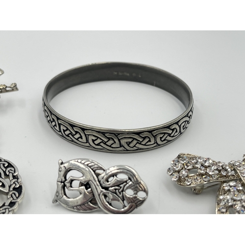 2418 - Six pieces of costume jewellery to include St Justin pewter brooch and bangle etc.