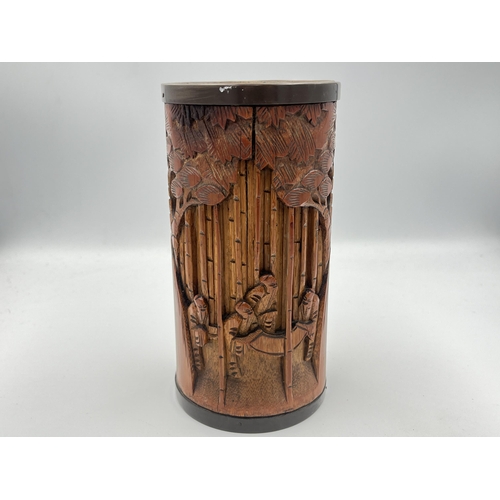 2317 - A Japanese heavily carved bamboo and brass rimmed brush pot